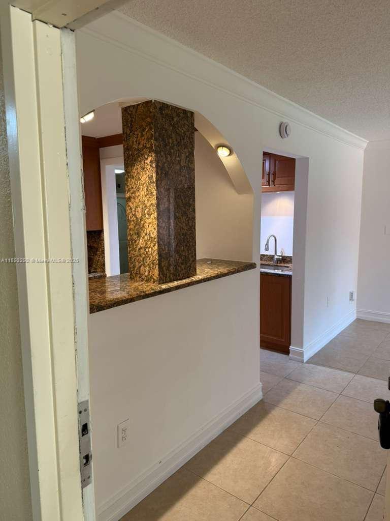 7000 Northwest 186th Street, Unit 4129A Hialeah, FL 33015 - Photo 2 of 7 a view of a hallway with two chairs