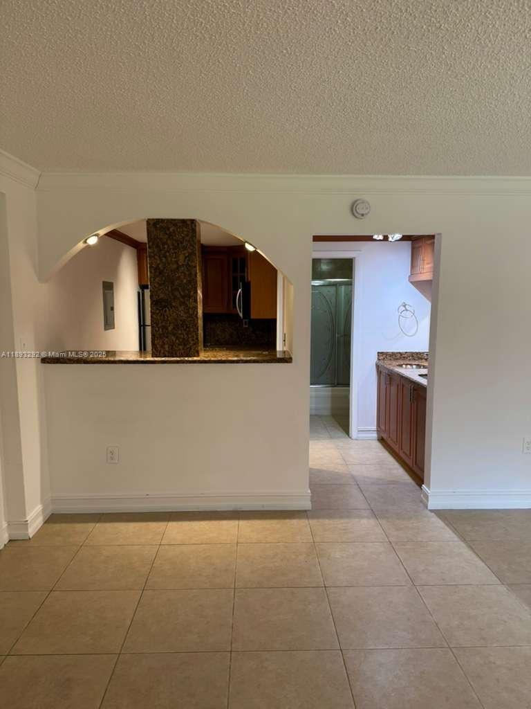 7000 Northwest 186th Street, Unit 4129A Hialeah, FL 33015 - Photo 3 of 7 a kitchen with stainless steel appliances granite countertop a refrigerator and a stove
