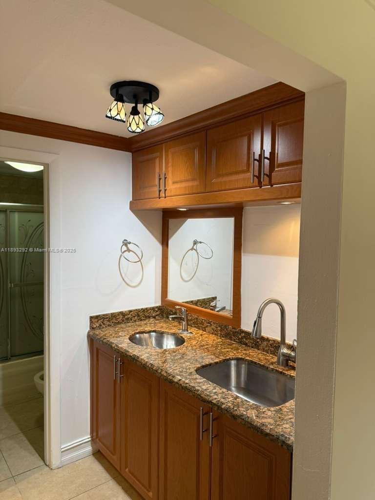 7000 Northwest 186th Street, Unit 4129A Hialeah, FL 33015 - Photo 5 of 7 a kitchen with a sink and a stove top oven