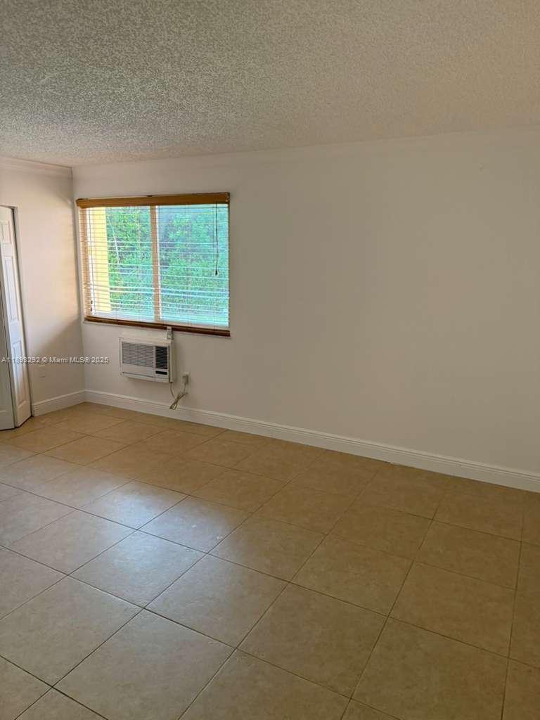 7000 Northwest 186th Street, Unit 4129A Hialeah, FL 33015 - Photo 6 of 7 an empty room with windows
