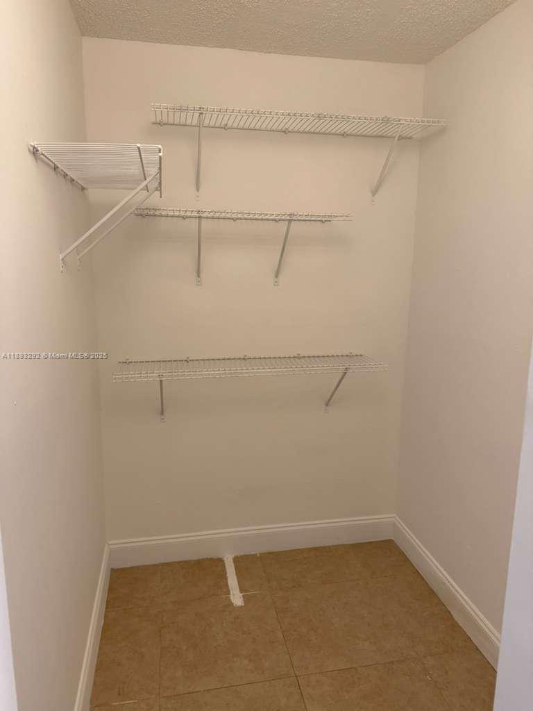 7000 Northwest 186th Street, Unit 4129A Hialeah, FL 33015 - Photo 7 of 7 a view of a room with racks on the wall