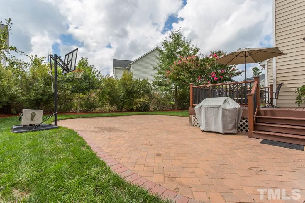 404 Powers Ferry Road Cary, NC 27519 - Photo 21 of 25 Extra large brick patio completes this beautiful backyard. Maintenance-free Trek deck. A perfect space for outdoor entertainment.