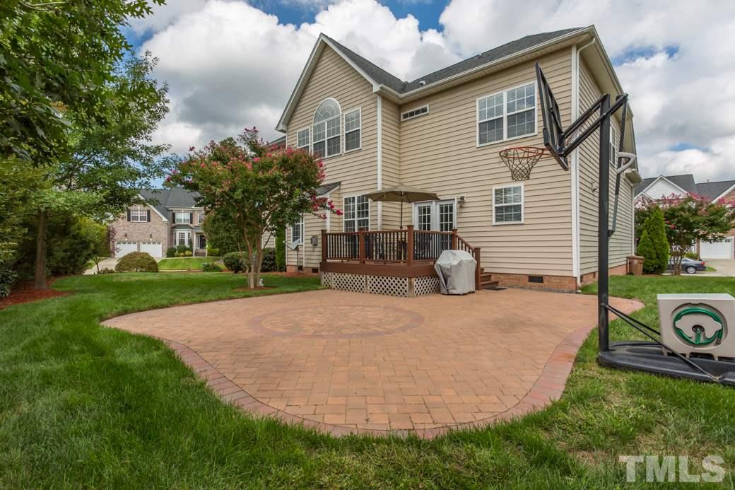 404 Powers Ferry Road Cary, NC 27519 - Photo 22 of 25 Professionally-landscaped backyard with brick patio designed with decorative center.