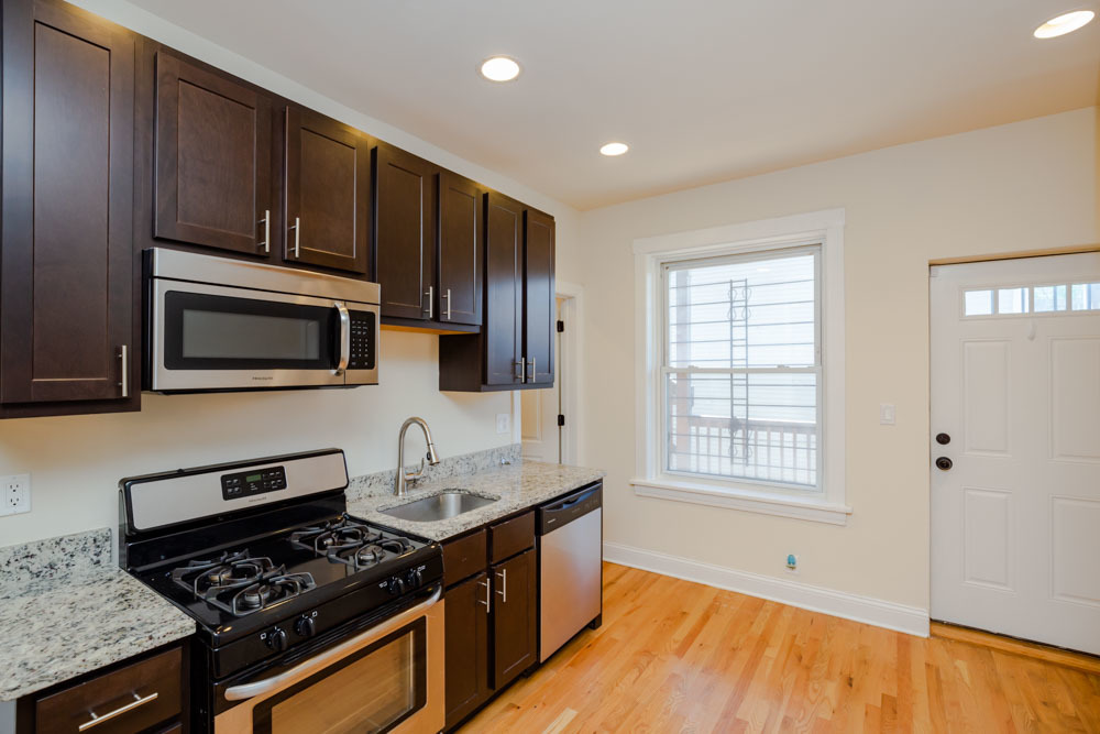2641 West George Street, Unit 1 Chicago, IL 60618 - Photo 3 of 11 a kitchen with stainless steel appliances a stove a microwave and sink