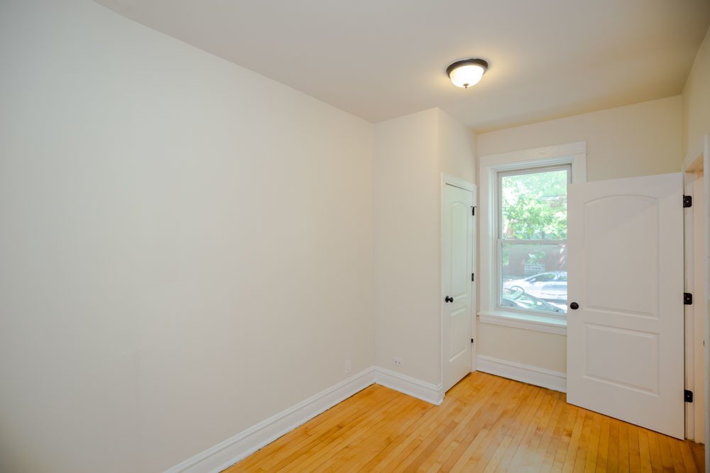 2641 West George Street, Unit 1 Chicago, IL 60618 - Photo 5 of 11 a view of a room with wooden floor and cabinet