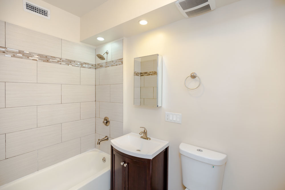 2641 West George Street, Unit 1 Chicago, IL 60618 - Photo 7 of 11 a bathroom with a sink toilet and shower