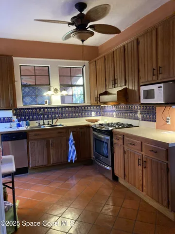 a front view of a house with a yard and fountain