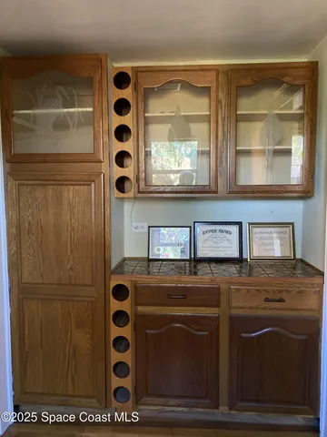 a view of a patio with table and chairs and potted plants