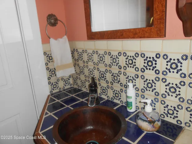 a front view of a house with a yard and tree