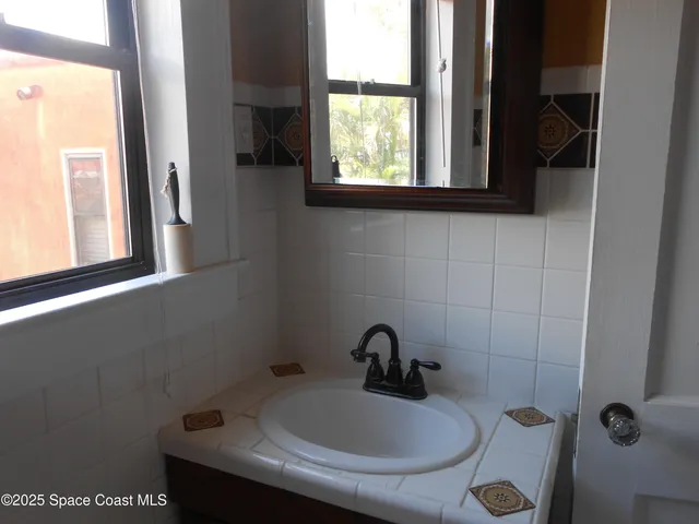 a wooden bench sitting in front of a house