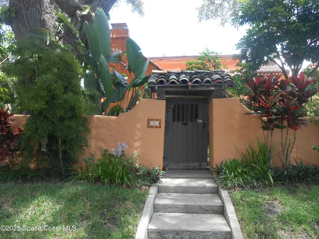 a front view of a house with a yard garage and outdoor seating