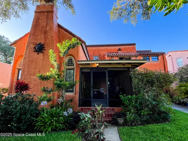 a room with furniture a window and a potted plant