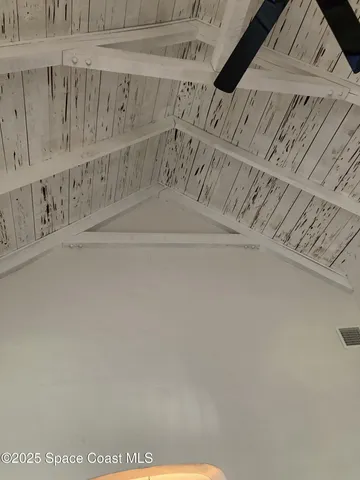 a living room with couches and dining table with wooden floor