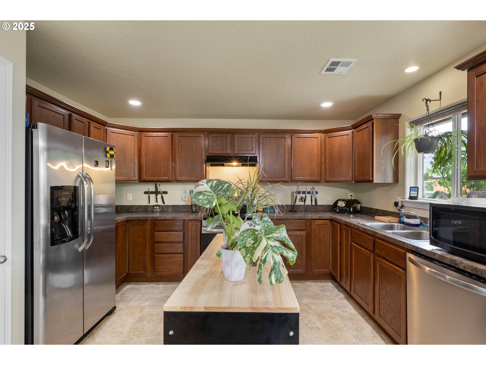 335 Gentry Loop Myrtle Creek, OR 97457 - Photo 12 of 41 a kitchen with stainless steel appliances granite countertop a refrigerator a sink dishwasher a stove with wooden cabinets