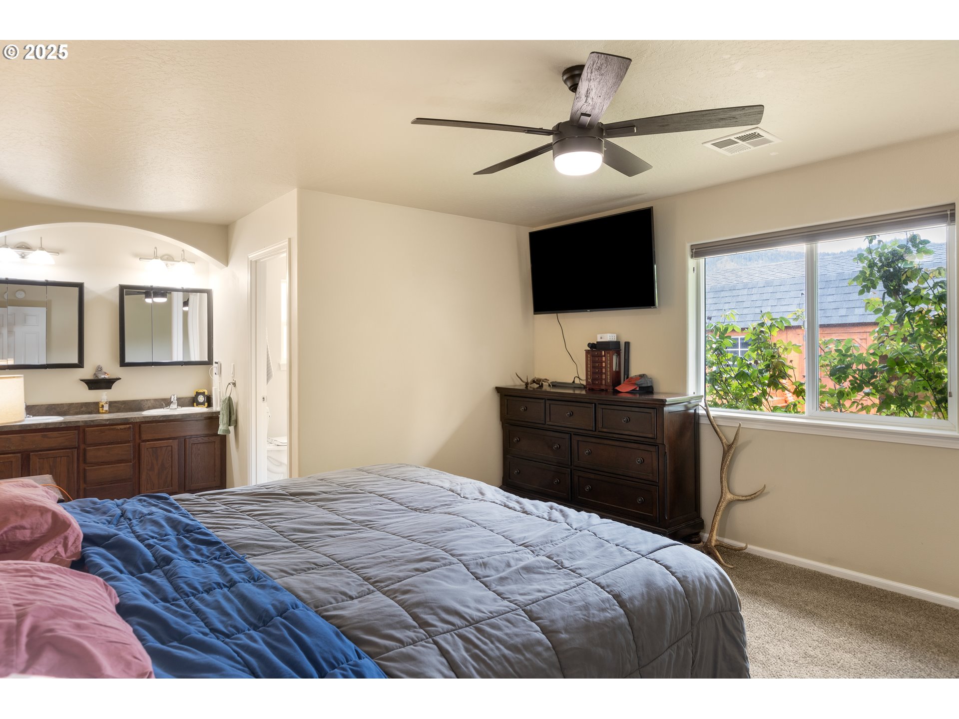 335 Gentry Loop Myrtle Creek, OR 97457 - Photo 15 of 41 a bedroom with a bed and a flat screen tv