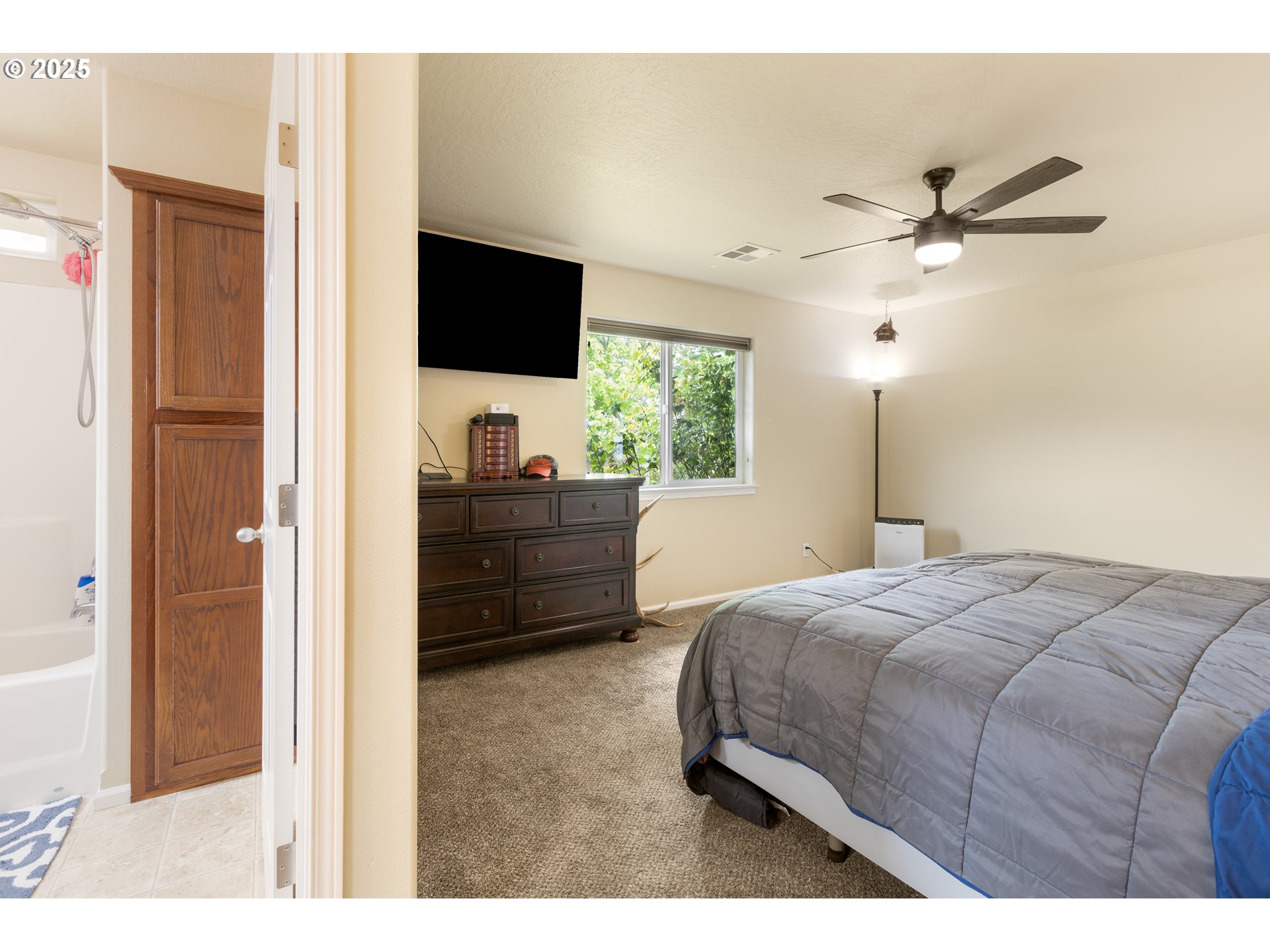 335 Gentry Loop Myrtle Creek, OR 97457 - Photo 18 of 41 a bedroom with a bed and a flat screen tv