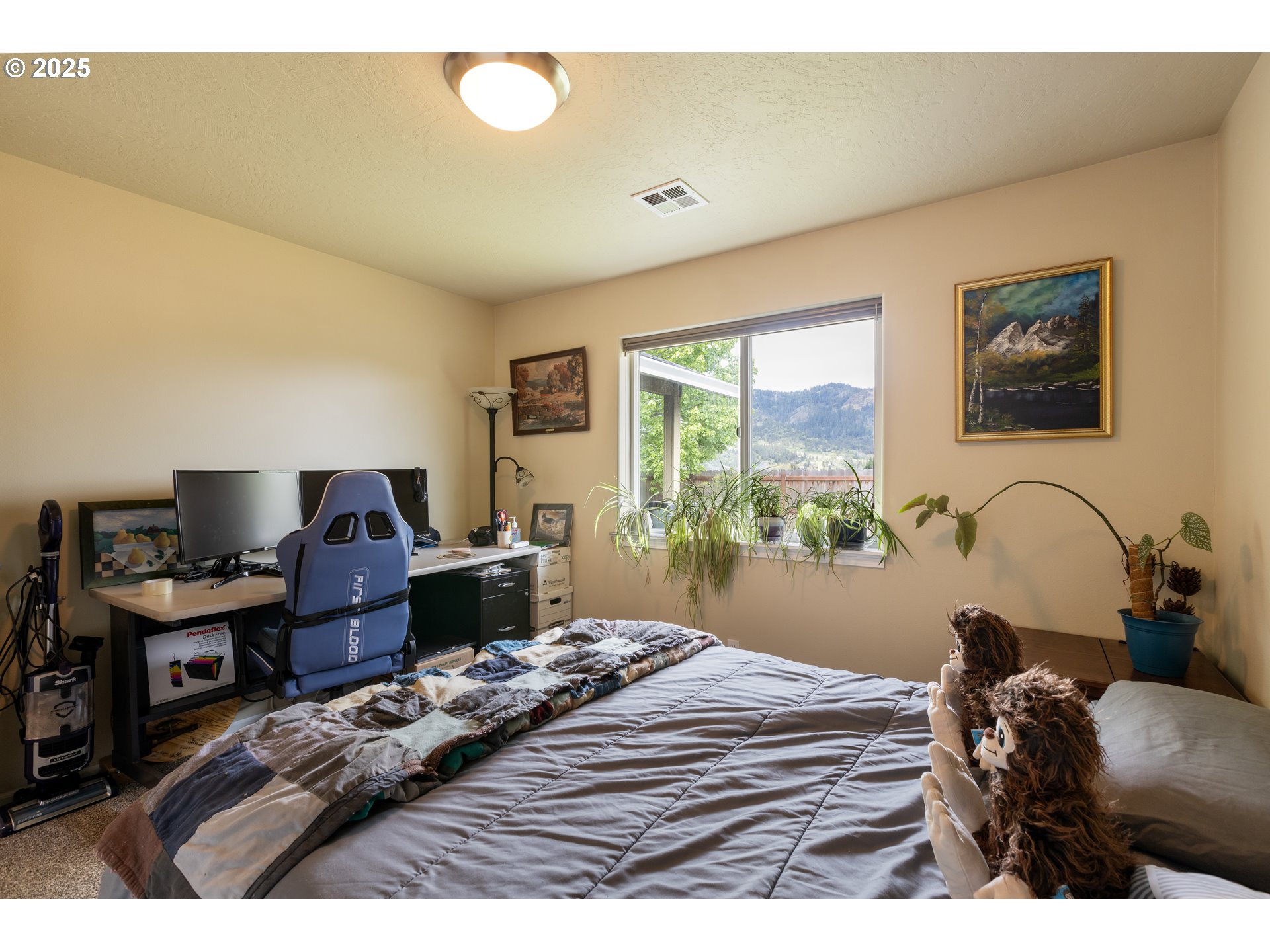 335 Gentry Loop Myrtle Creek, OR 97457 - Photo 25 of 41 a bedroom with a bed and a computer on the desk next to a window
