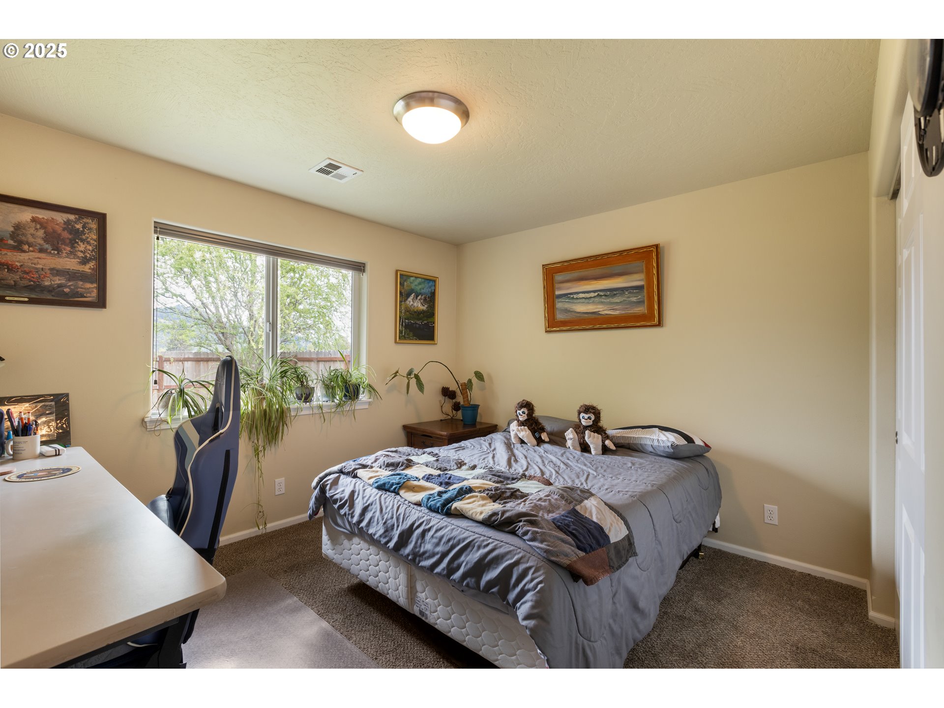 335 Gentry Loop Myrtle Creek, OR 97457 - Photo 26 of 41 a bedroom with a bed and wooden floor