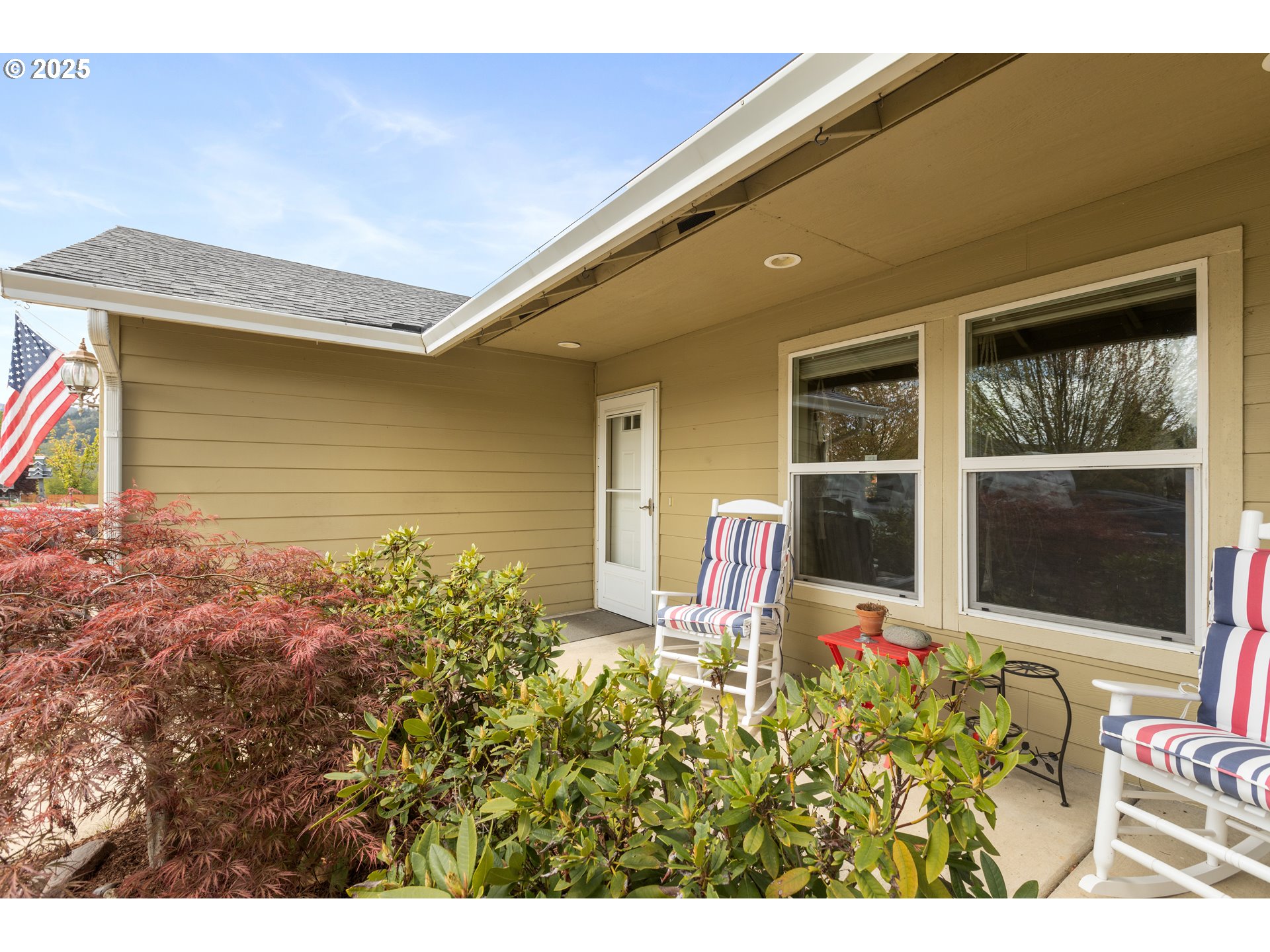 335 Gentry Loop Myrtle Creek, OR 97457 - Photo 3 of 41 a front view of a house with a large window and potted plants