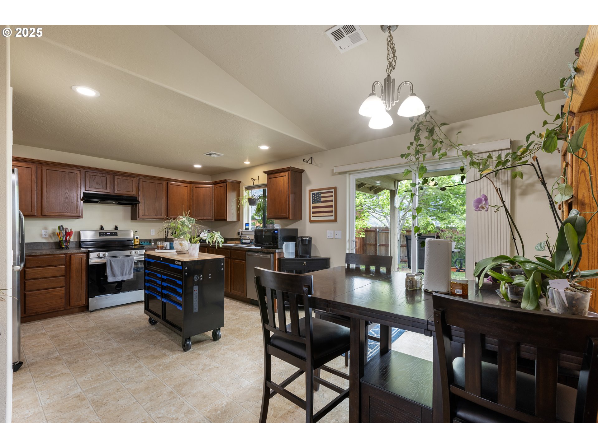 335 Gentry Loop Myrtle Creek, OR 97457 - Photo 8 of 41 a kitchen with a dining table chairs and refrigerator