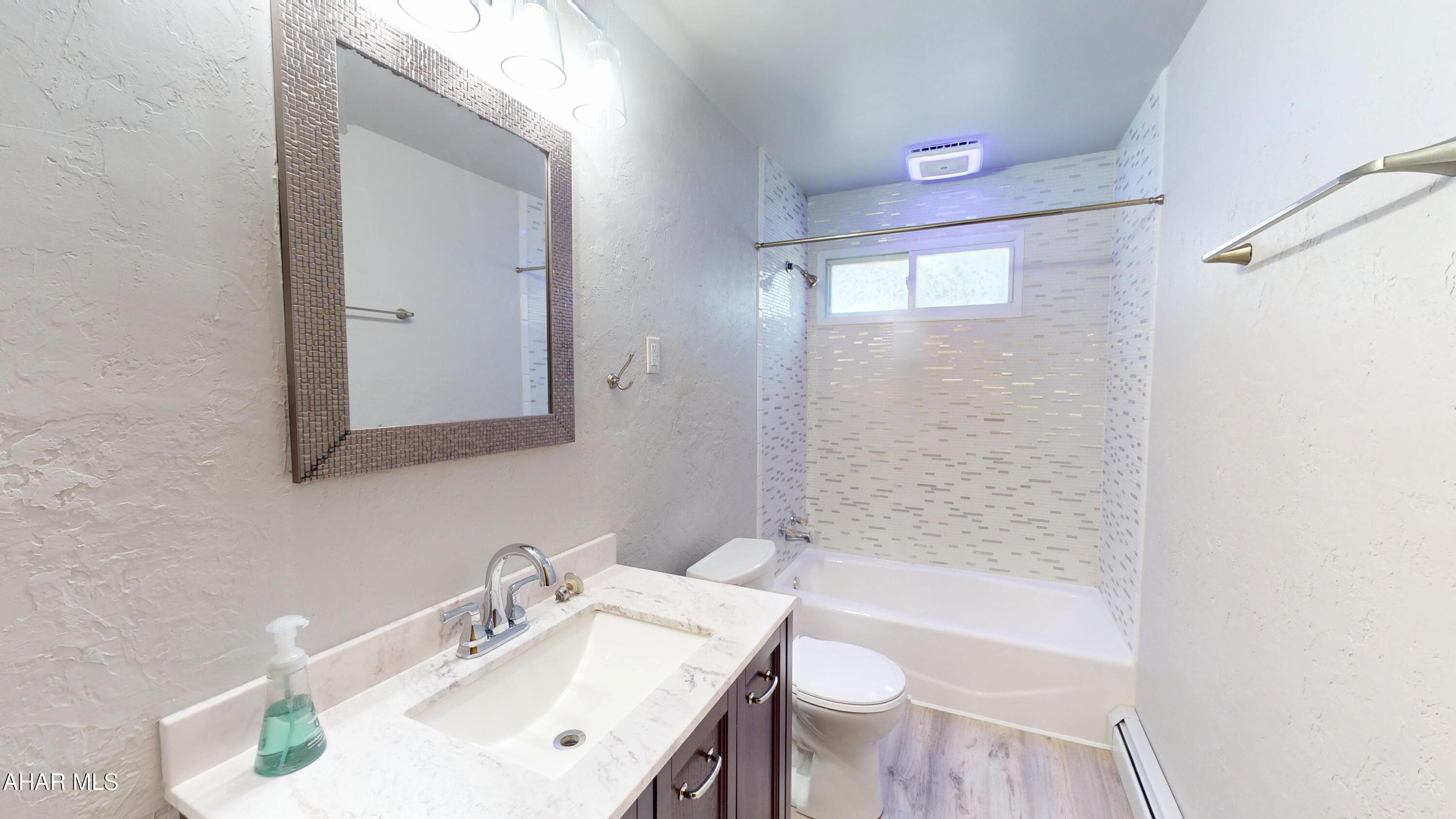 871 Decker Hollow Road Tyrone, PA 16686 - Photo 21 of 35 a bathroom with a bathtub shower sink vanity and toilet