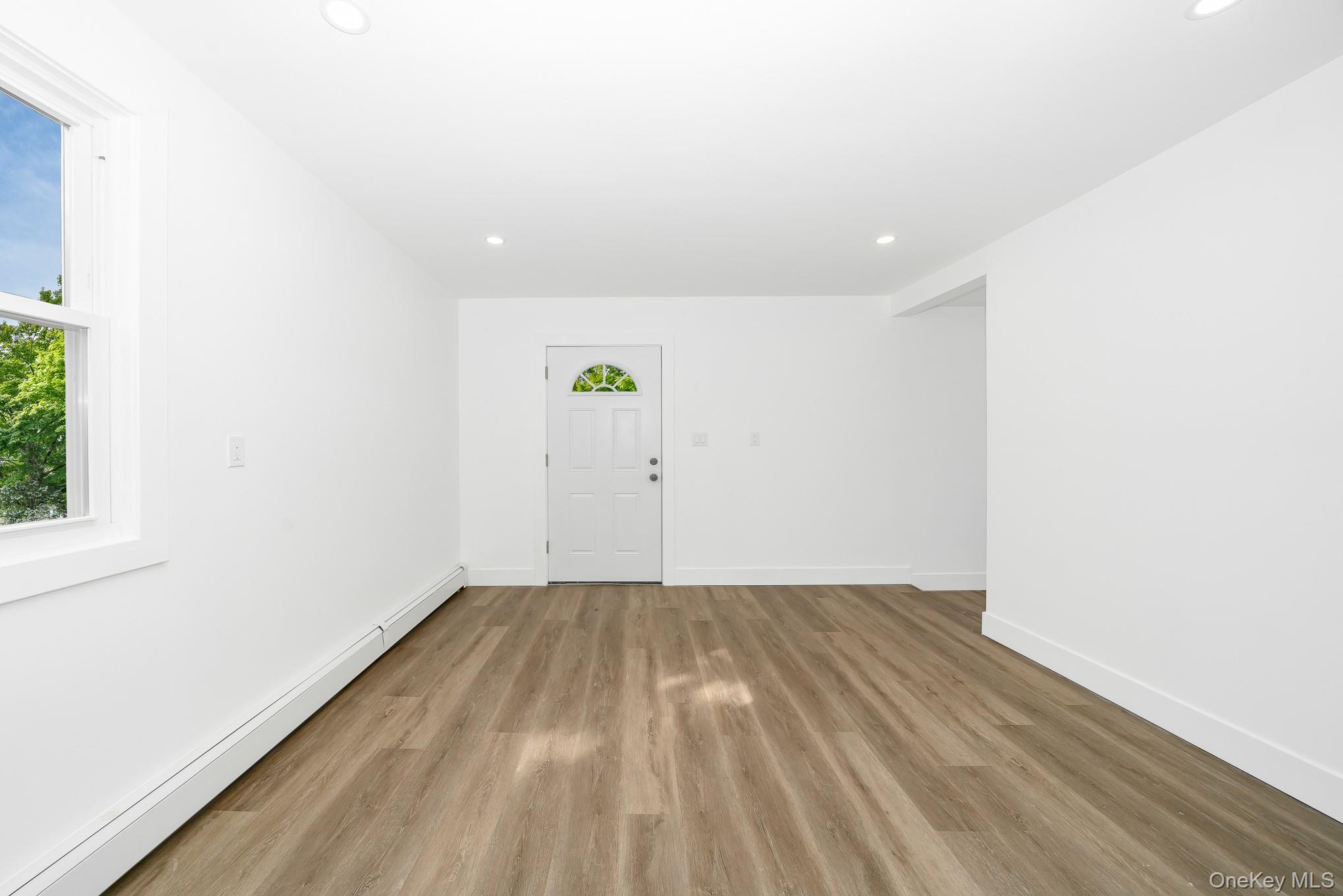 24 Calvert Avenue West Babylon, NY 11704 - Photo 11 of 28 Entrance foyer featuring a baseboard radiator, recessed lighting, and wood finished floors