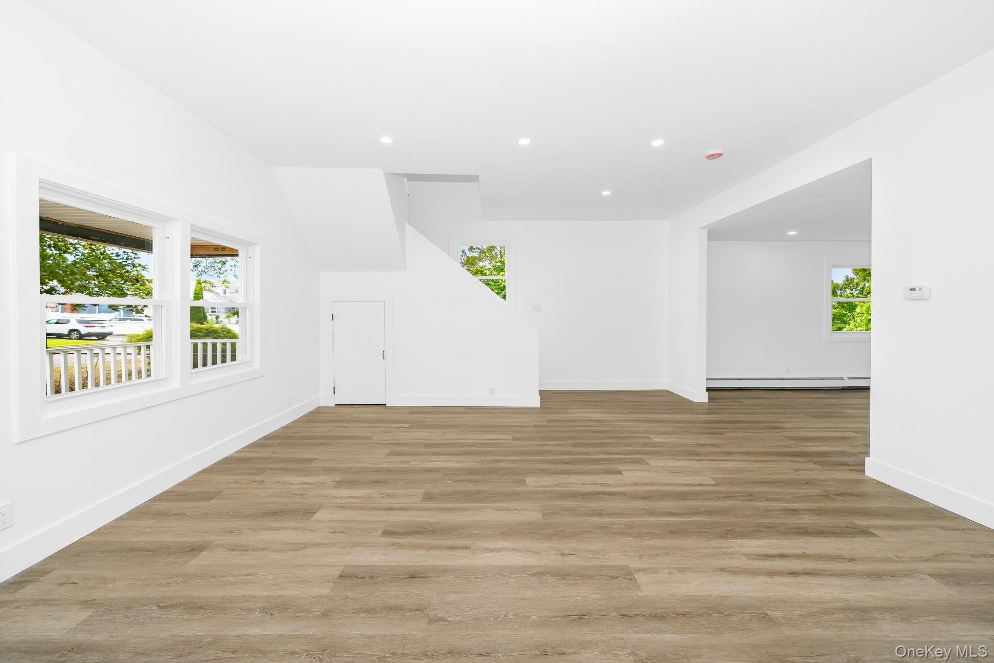 24 Calvert Avenue West Babylon, NY 11704 - Photo 14 of 28 Unfurnished living room featuring recessed lighting, light wood-style flooring, and baseboard heating