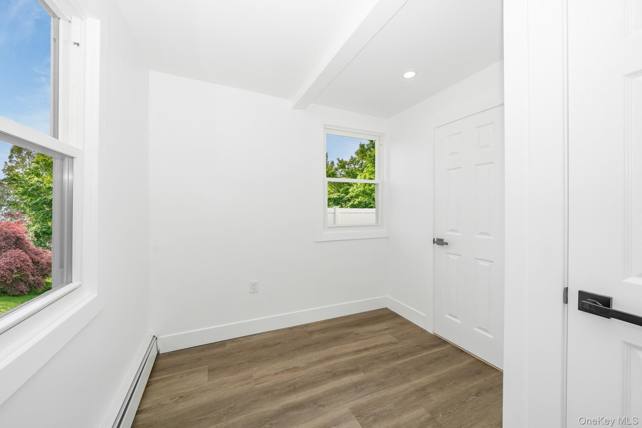 24 Calvert Avenue West Babylon, NY 11704 - Photo 9 of 28 Spare room featuring wood finished floors, a baseboard heating unit, and recessed lighting