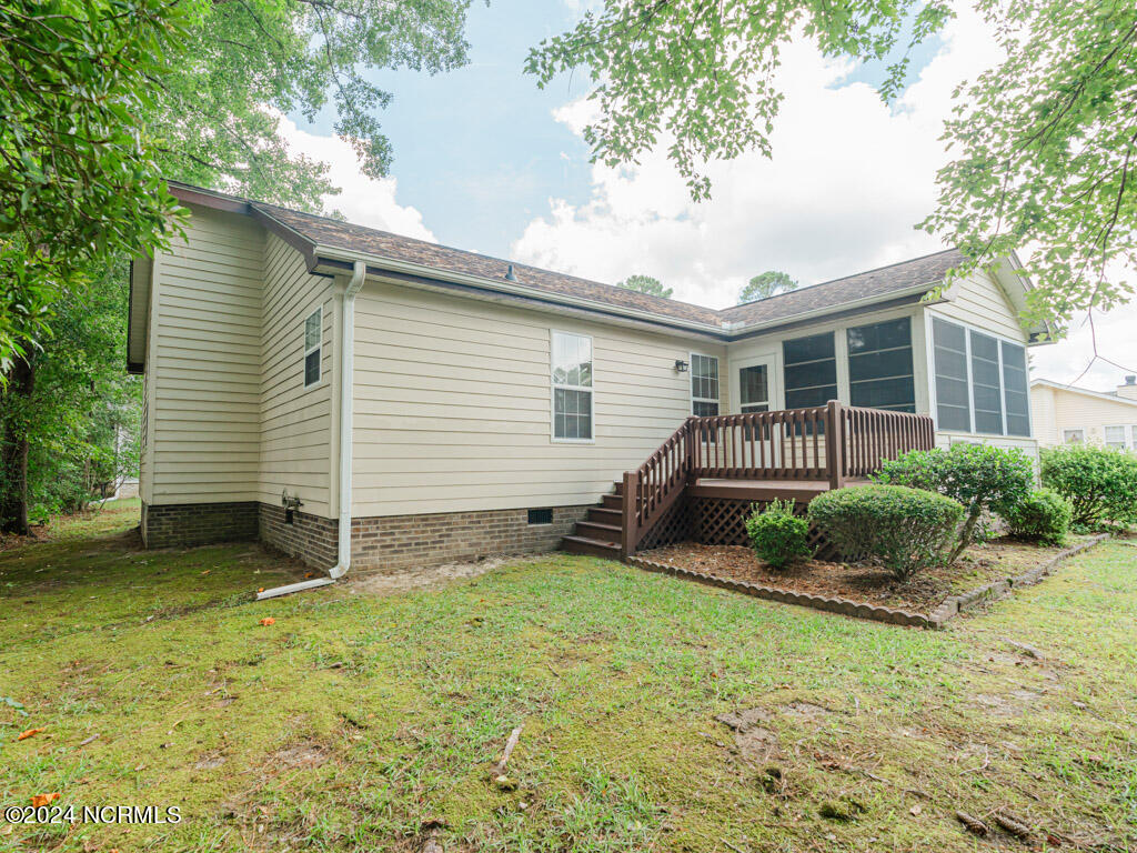 417 Deer Path Calabash, NC 28467 - Photo 21 of 32 Right off of the Sun Room is this open deck which is a versatile addition to your backyard and provides an exceptional space to enjoy outdoor views while entertaining.