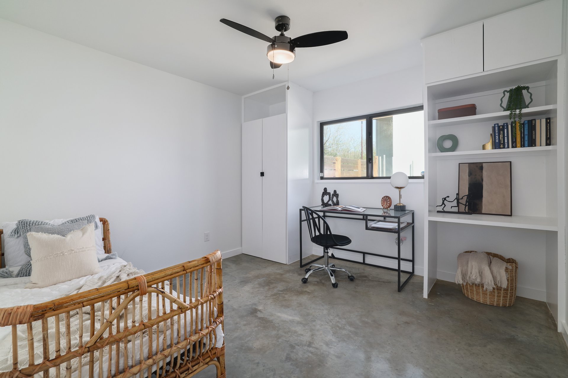 1310 Green Street Lockhart, TX 78644 - Photo 14 of 25 Bedroom with ceiling fan, concrete floors, and an office area