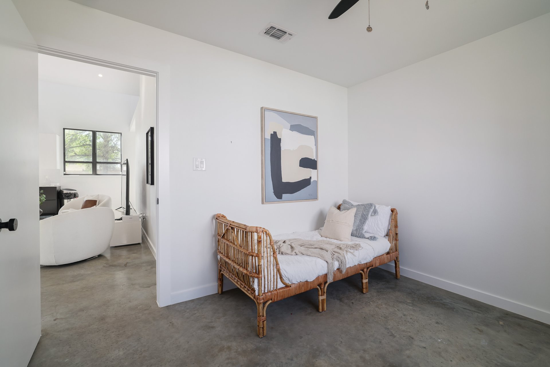 1310 Green Street Lockhart, TX 78644 - Photo 15 of 25 Living area with finished concrete floors and a ceiling fan