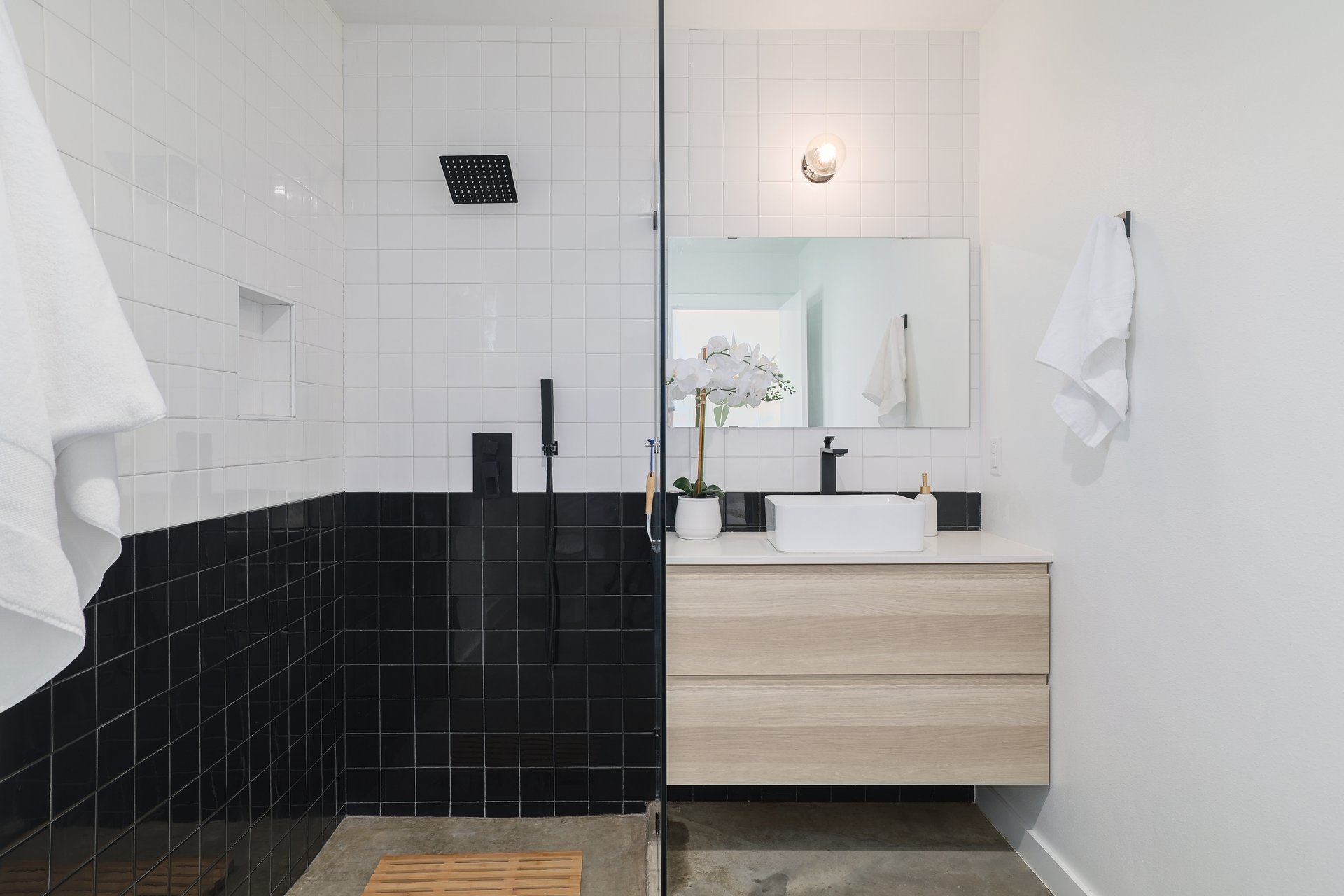 1310 Green Street Lockhart, TX 78644 - Photo 18 of 25 Bathroom with vanity, walk in shower, and tile walls