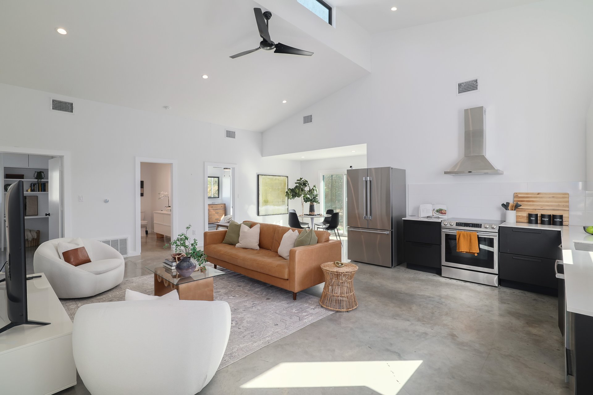 1310 Green Street Lockhart, TX 78644 - Photo 5 of 25 Living room with finished concrete floors, ceiling fan, recessed lighting, and lofted ceiling