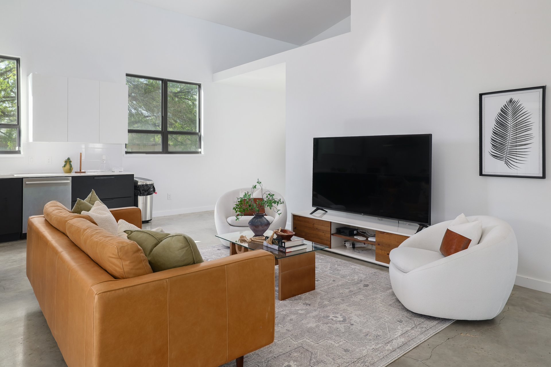 1310 Green Street Lockhart, TX 78644 - Photo 10 of 25 Living room featuring concrete flooring and vaulted ceiling