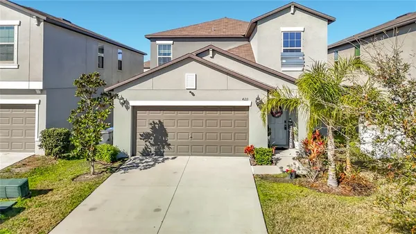 a front view of a house with a yard and garage