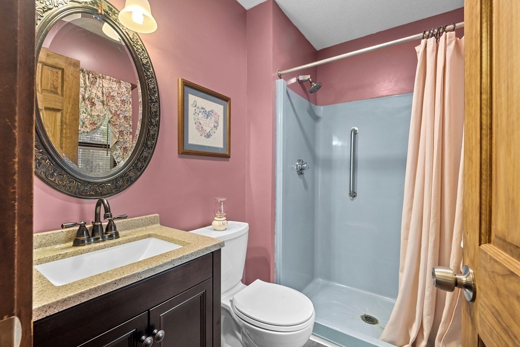 266 Southampton Road Westhampton, MA 01027 - Photo 17 of 26 a bathroom with a sink a toilet a mirror and shower