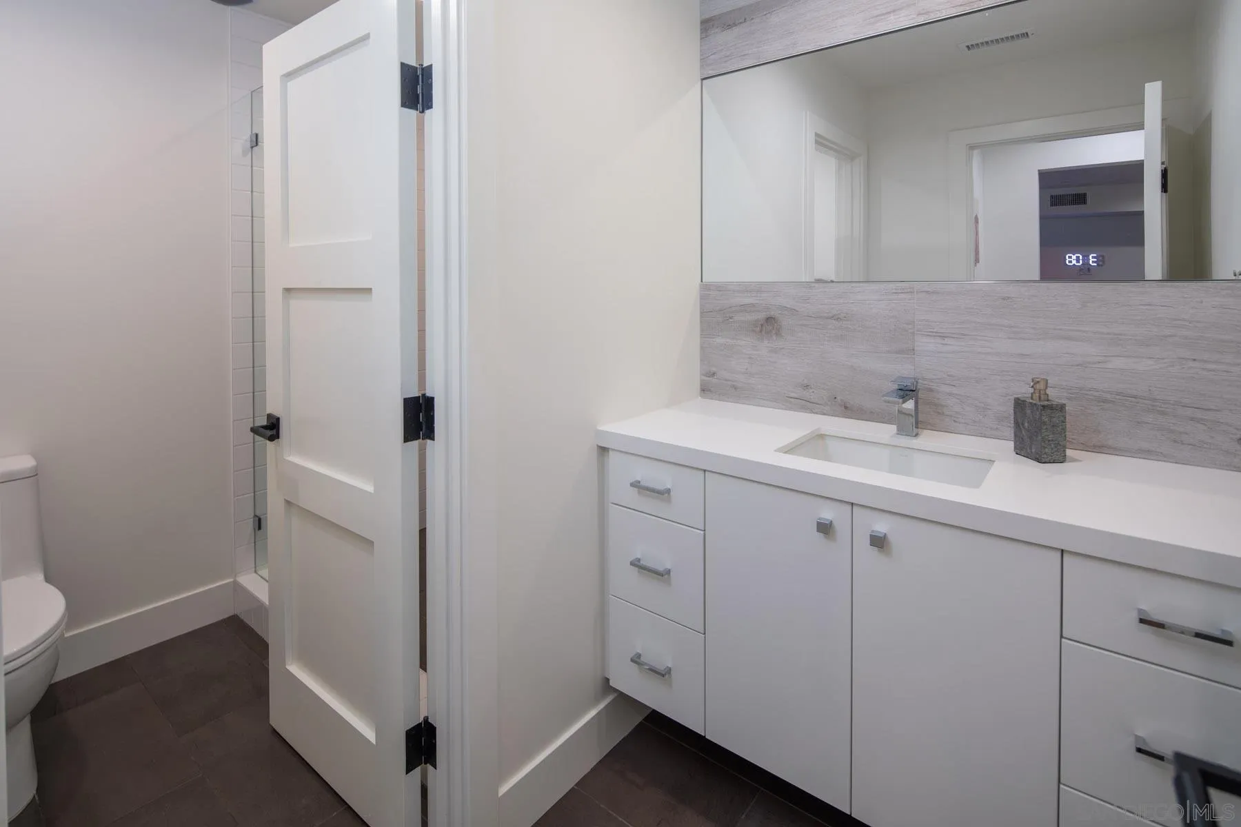 307 La Mesa Avenue Encinitas, CA 92024 - Photo 13 of 33 a bathroom with a sink and mirror