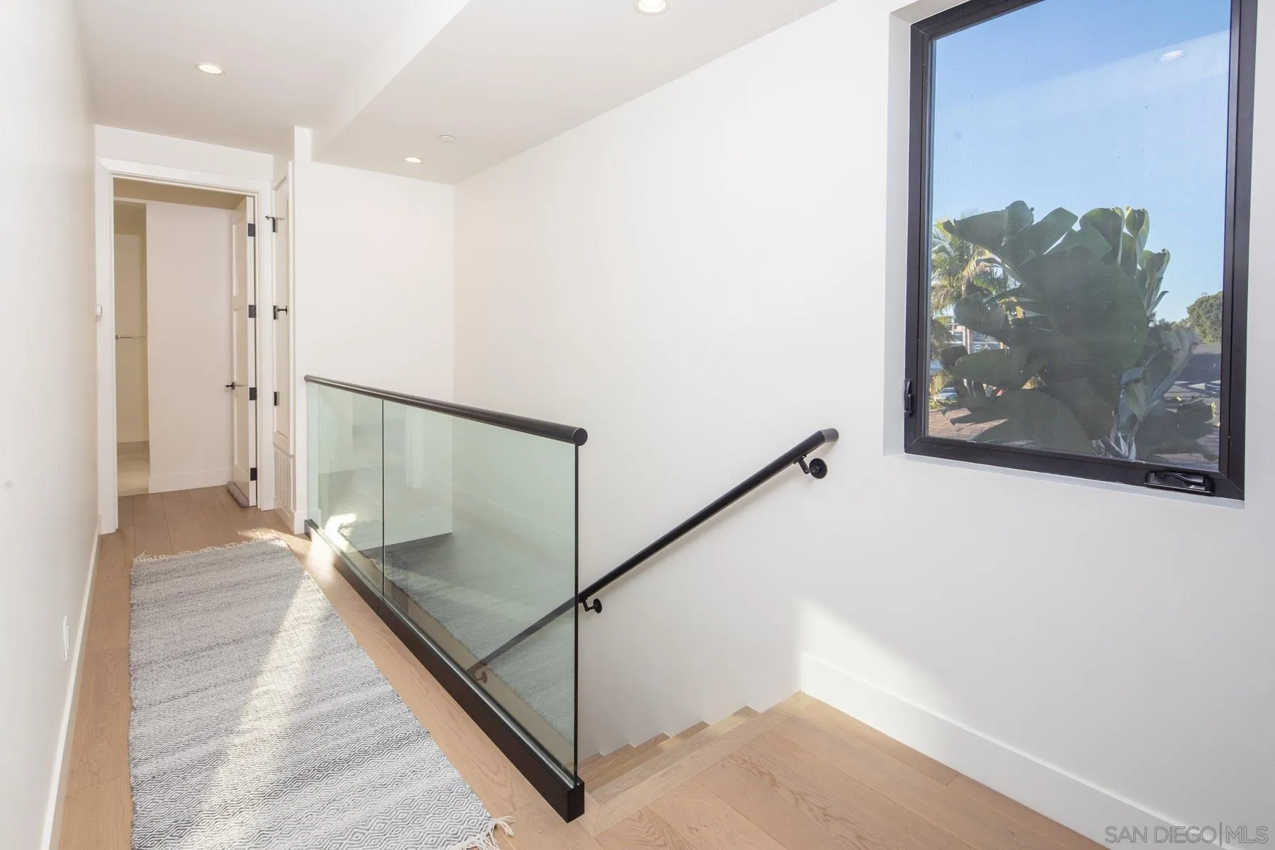 307 La Mesa Avenue Encinitas, CA 92024 - Photo 14 of 33 a view of a hallway with wooden floor and a bathroom