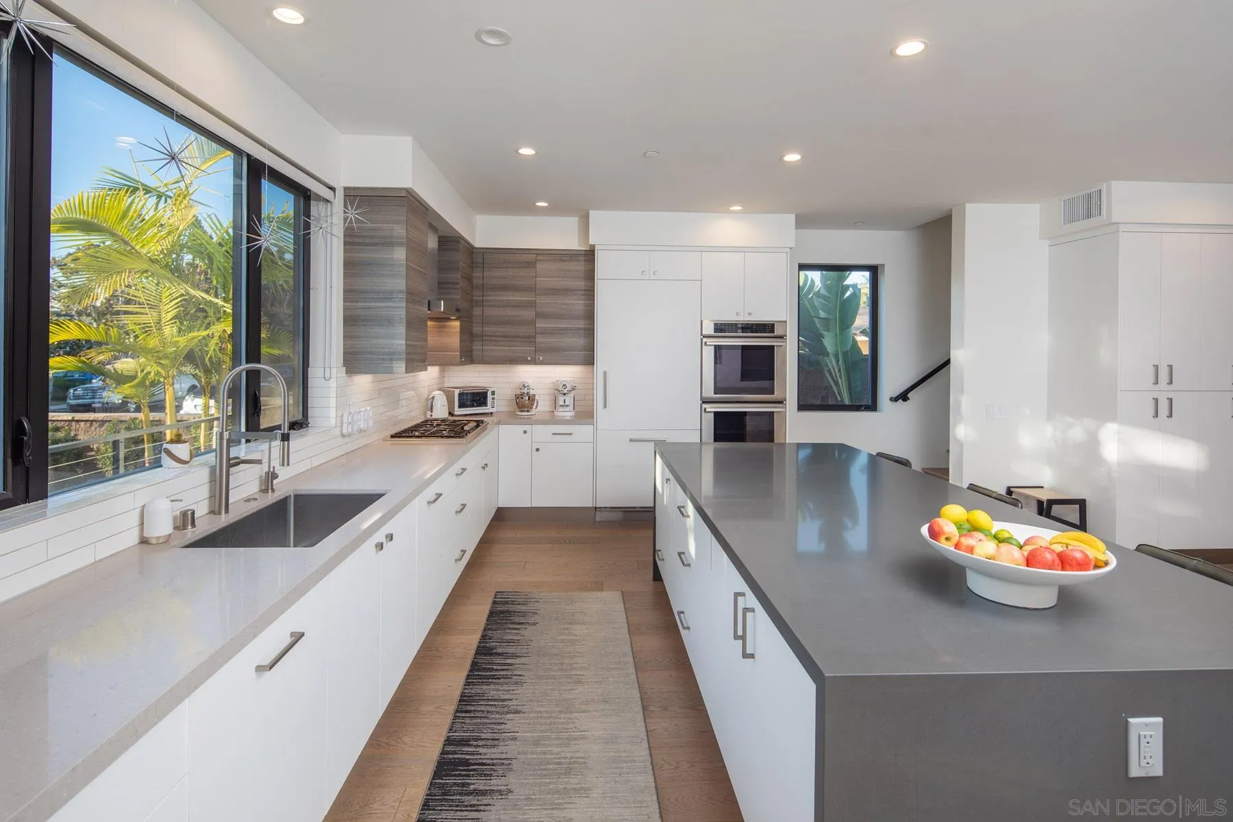 307 La Mesa Avenue Encinitas, CA 92024 - Photo 3 of 33 a large kitchen with stainless steel appliances kitchen island granite countertop a large counter top a stove and a sink