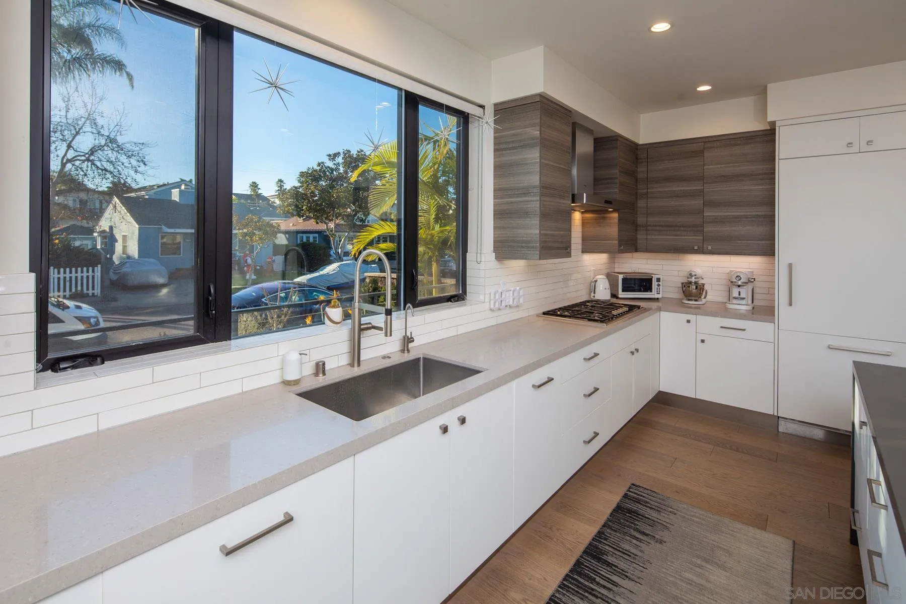 307 La Mesa Avenue Encinitas, CA 92024 - Photo 6 of 33 a large white kitchen with a double vanity sink and a large mirror