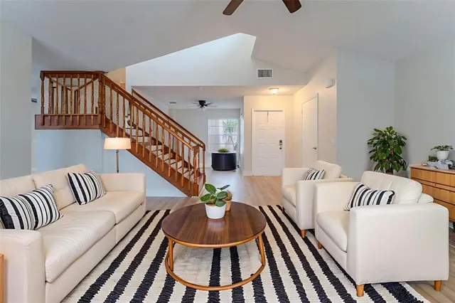 a living room with furniture and a potted plant
