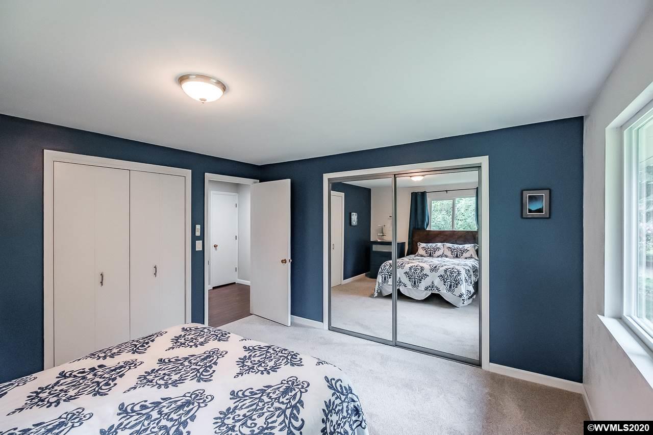 4890 Liberty Road Dallas, OR 97338 - Photo 29 of 42 a bedroom with a large bed and a window