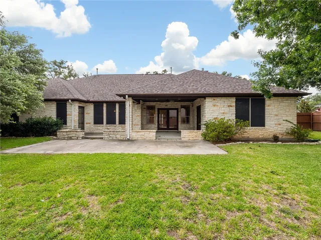 a front view of a house with yard patio and fire pit