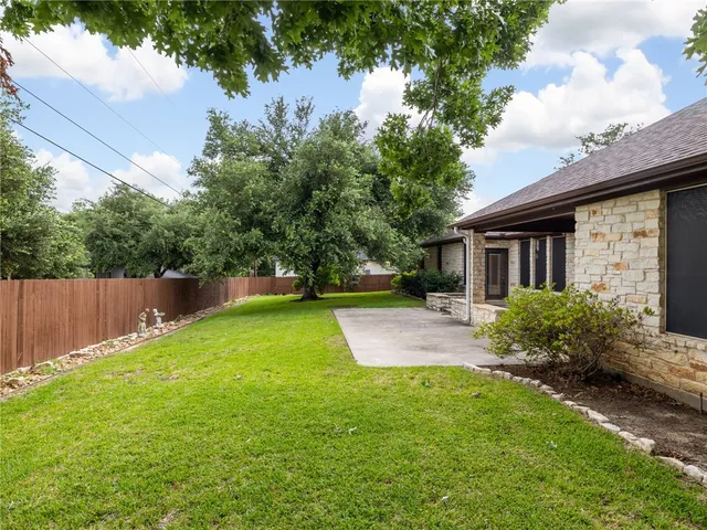 a view of a house with backyard and a garden