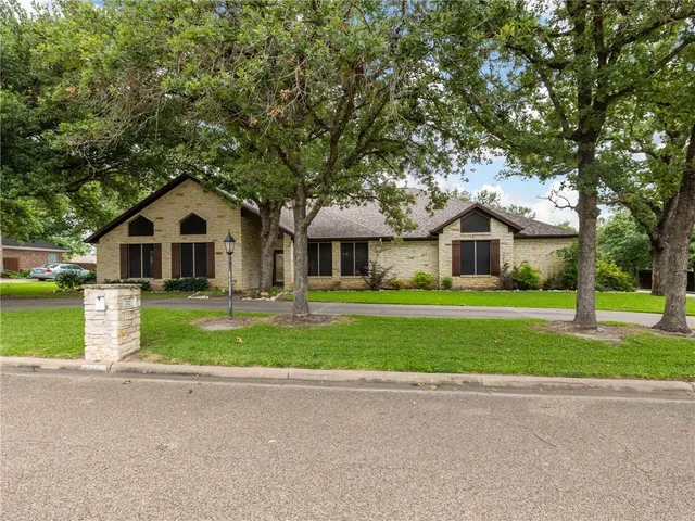 a front view of house with yard and green space