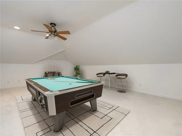 a room with pool table and windows
