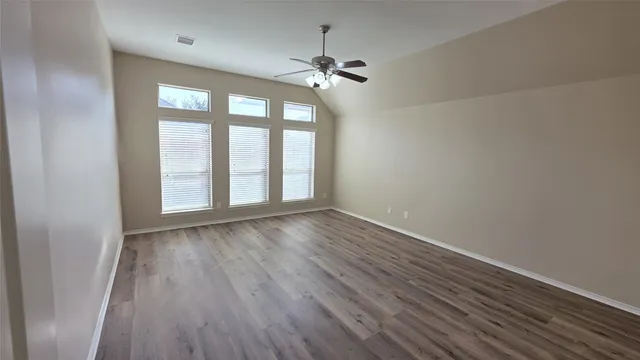 a view of a room with a ceiling fan and a chandelier fan