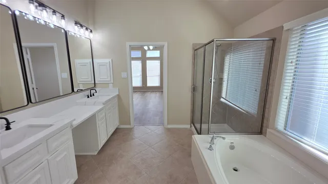 a bathroom with a bathtub and a shower
