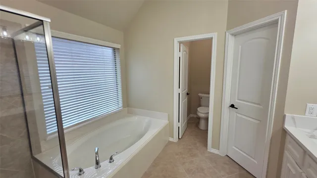 a white toilet sitting next to a sink