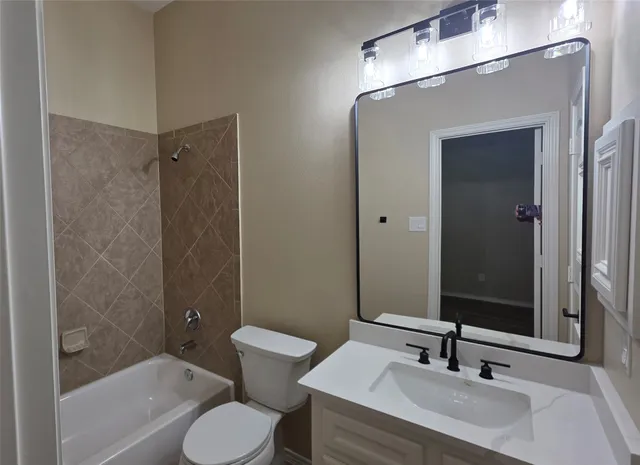 a white toilet sitting next to a bathroom sink